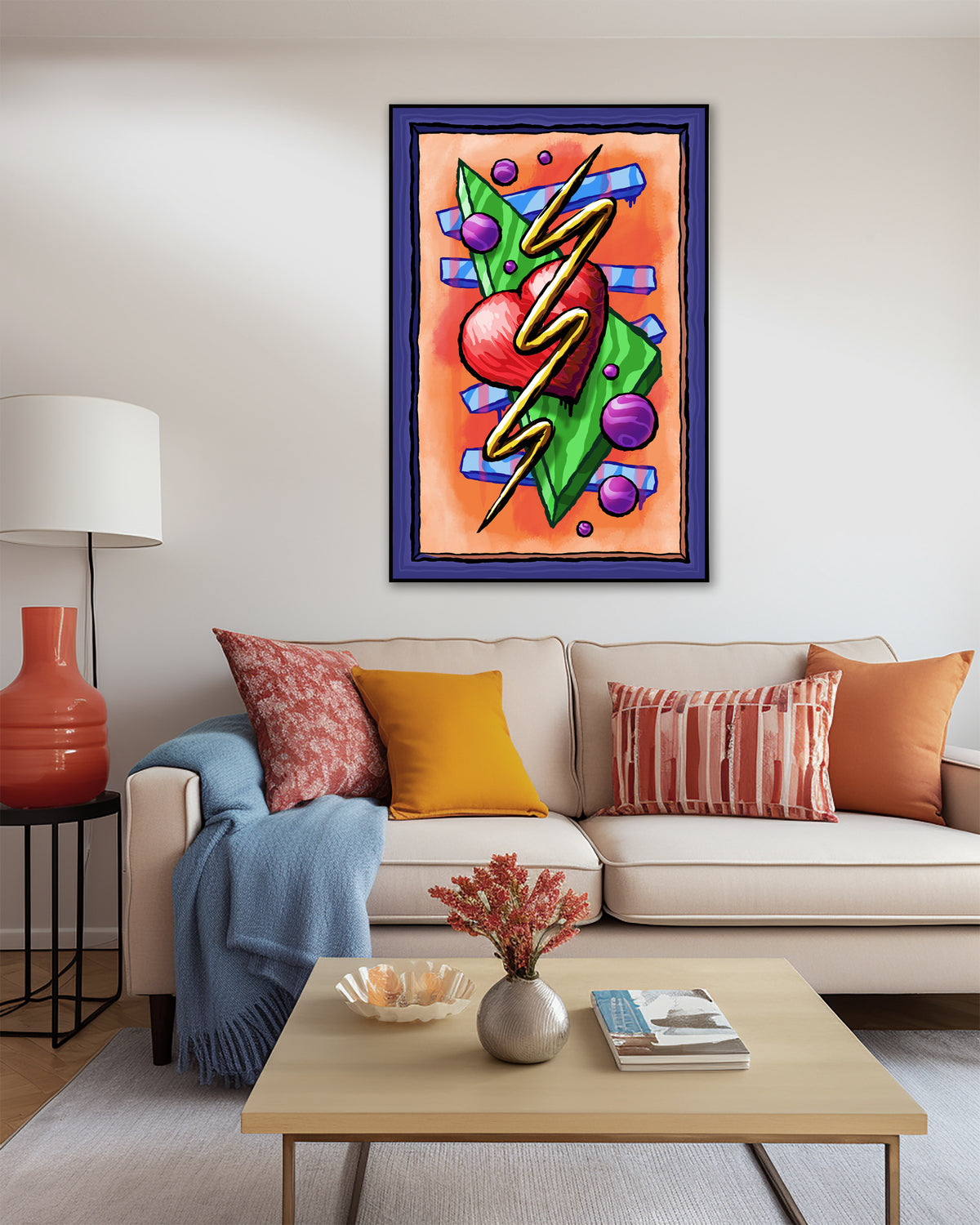 Zigzag Triangle Heart Dots art print above a cream sofa with orange and patterned cushions and a blue throw.